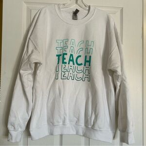 White Sweatshirt with ‘TEACH’ Graphic